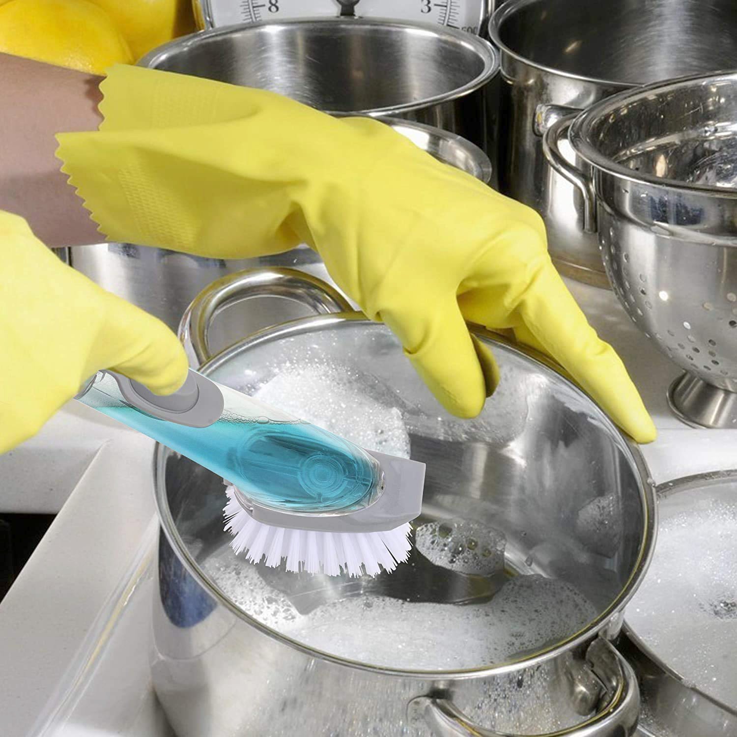 Kitchen cleaning brush demonstrating its soap dispensing function.
