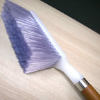 An efficient cleaning brush featuring firm, treated bristles for effective dirt removal.