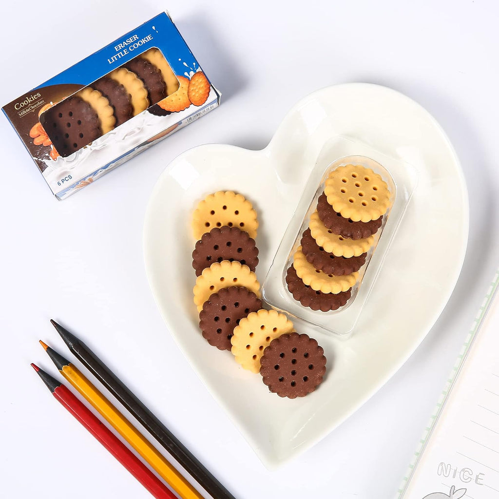 A hand holding a single biscuit eraser, demonstrating its compact size for school.