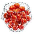 Elegant stainless steel wire foldable fruit basket displayed on a kitchen counter.