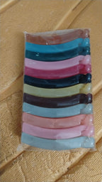 Hand holding plastic banana hair clips showing strong grip design