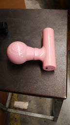 Black mini body massager presented in its retail box packaging.