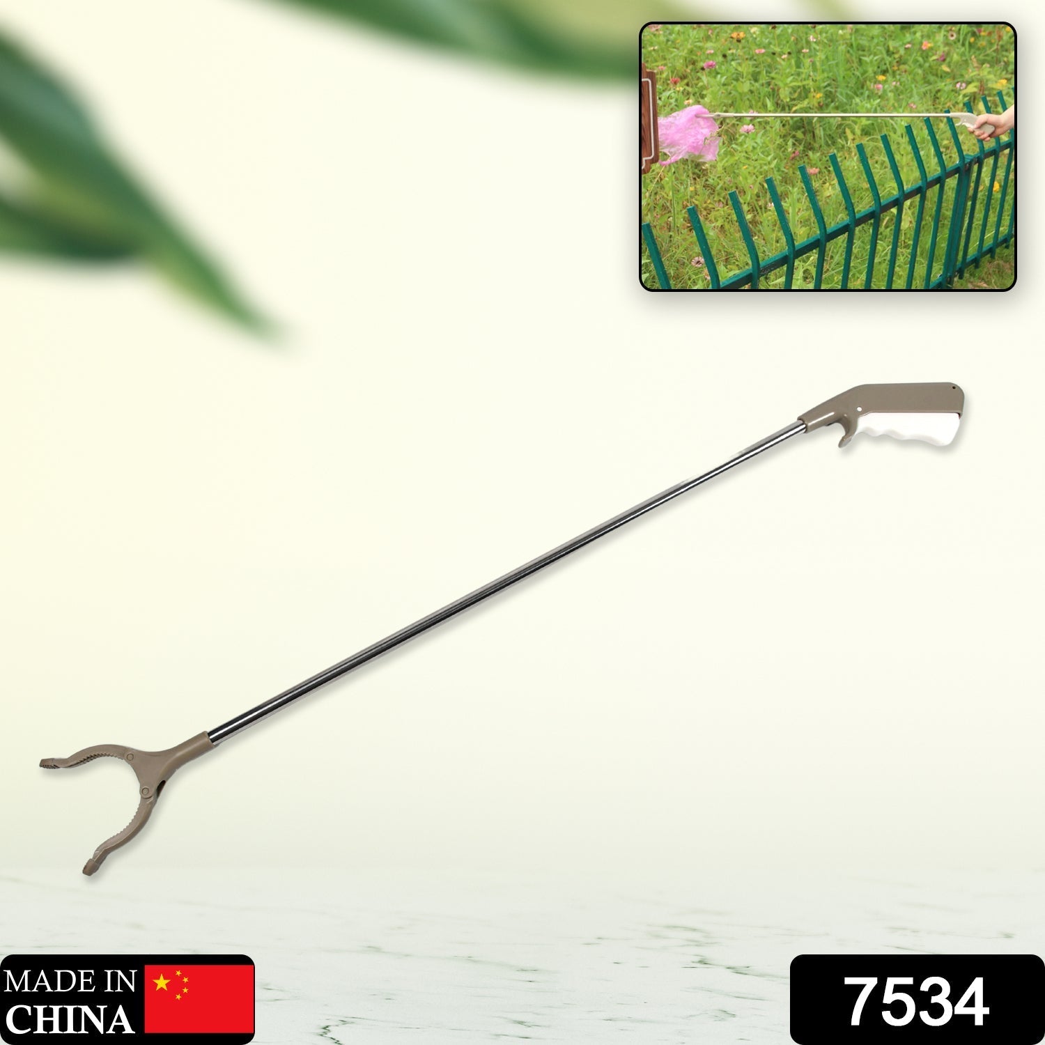 Ergonomic garbage picker tool with a comfortable grip for kitchen waste cleanup.