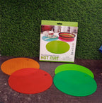 A red silicone hot pot mat flexed to show its durable and flexible construction.