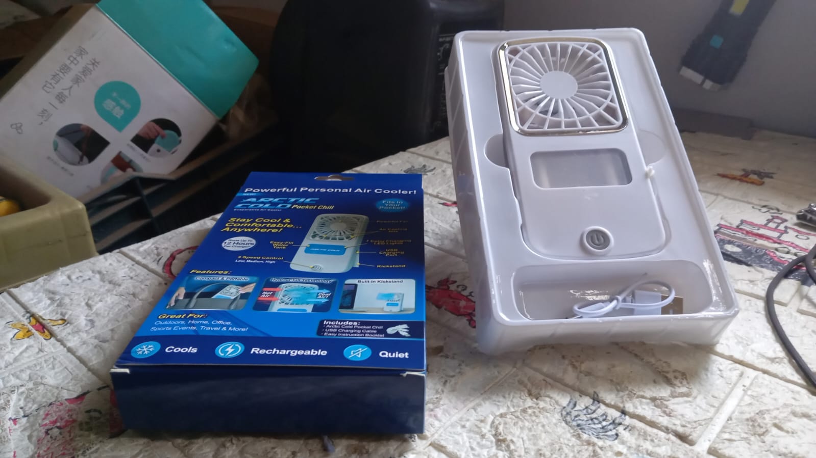 Lifestyle shot of the portable personal air cooler in use outdoors.