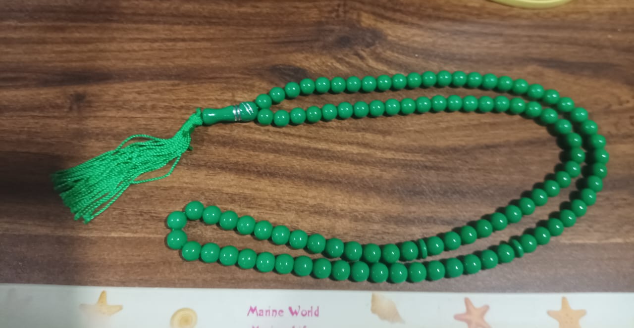 Textural close-up of Muslim prayer beads, highlighting the acrylic material.