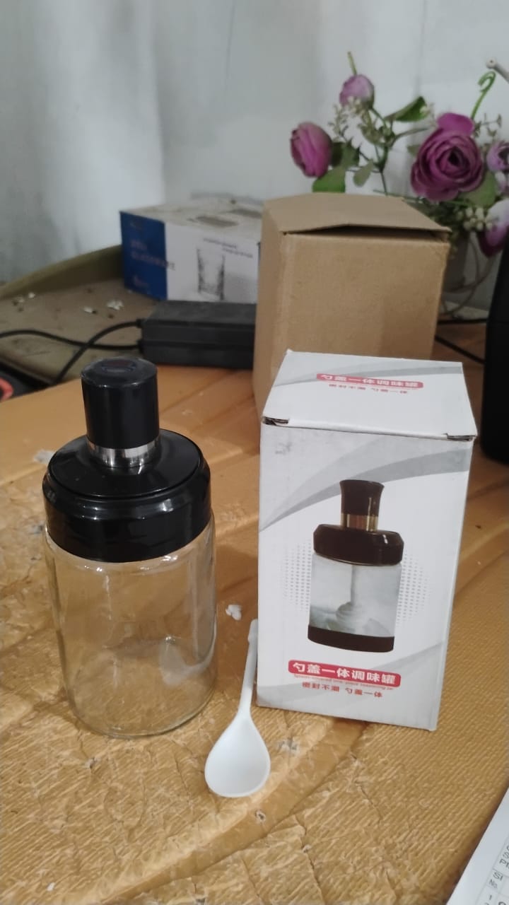 Modern glass storage jar with airtight lid and spoon for kitchen organization