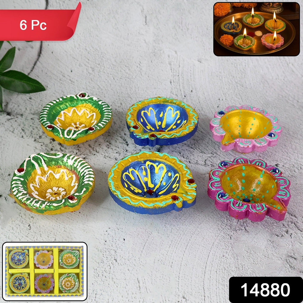 Close-up of decorative clay diyas with intricate traditional painting