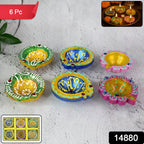 Close-up of decorative clay diyas with intricate traditional painting