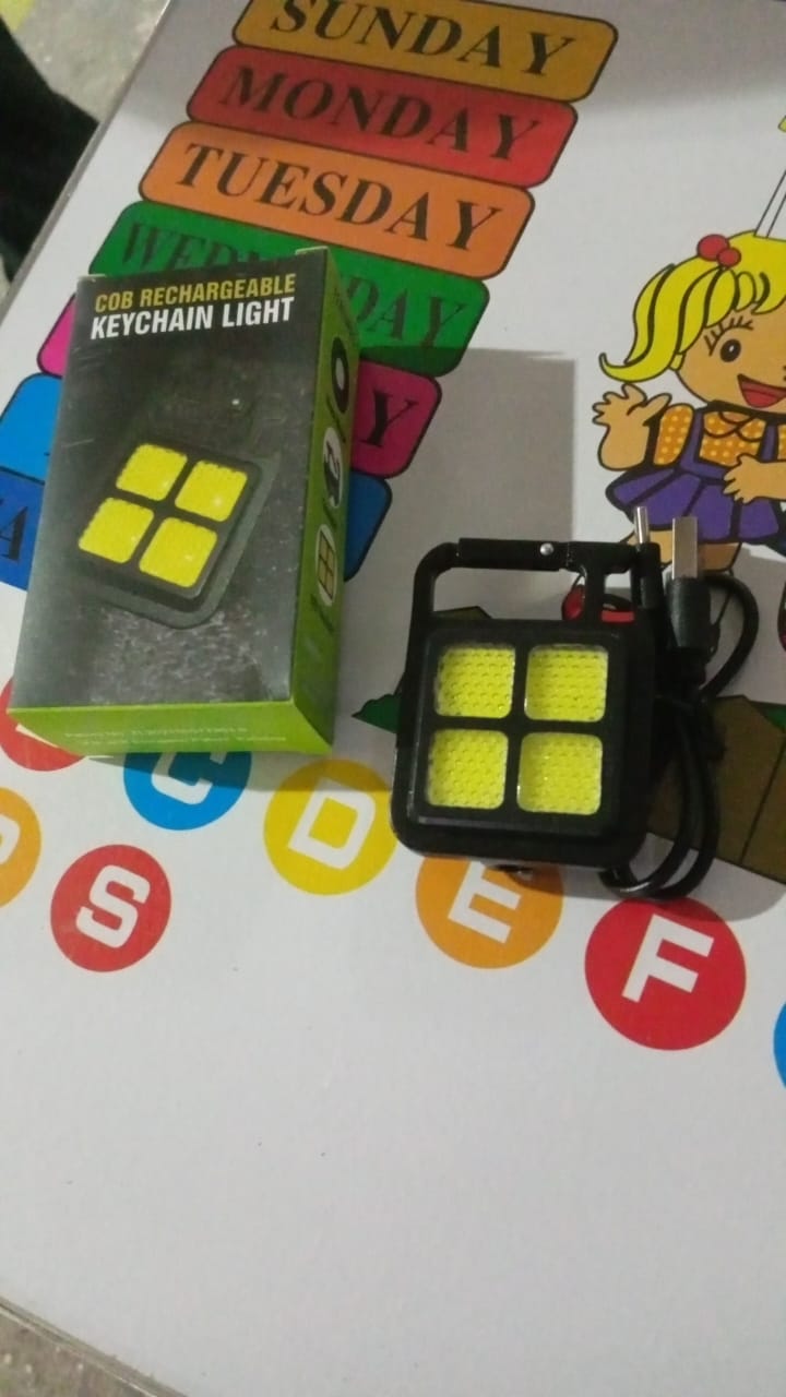 The compact 4 LED mini keychain light attached to a set of keys.