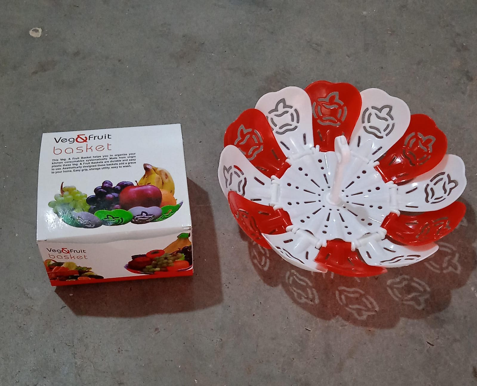 Stylish lifestyle shot of the folding fruit basket on a dining table, filled with fruits.