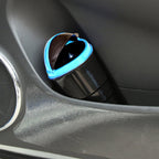 Multicolor plastic car dustbin with a spring lid, designed for easy trash disposal.
