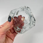 Durable crystal glass ashtray suitable for outdoor use on a patio table.
