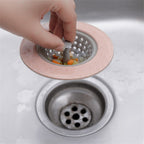 Silicone sink strainer basket actively in use within a busy kitchen sink.