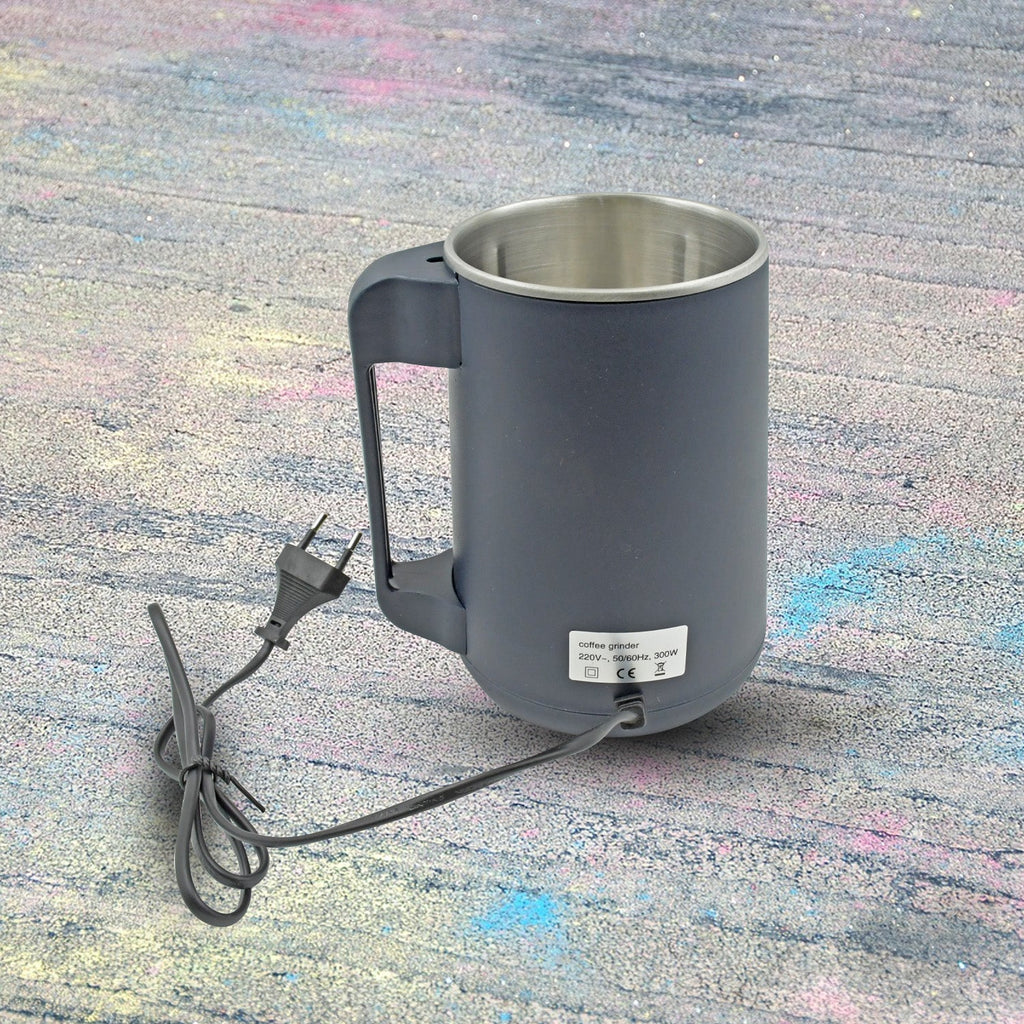 Hand pressing the one-touch button for easy operation of the home electric grinder.