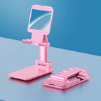 Adjustable phone stand with mirror on a desk, showcasing its compact design.
