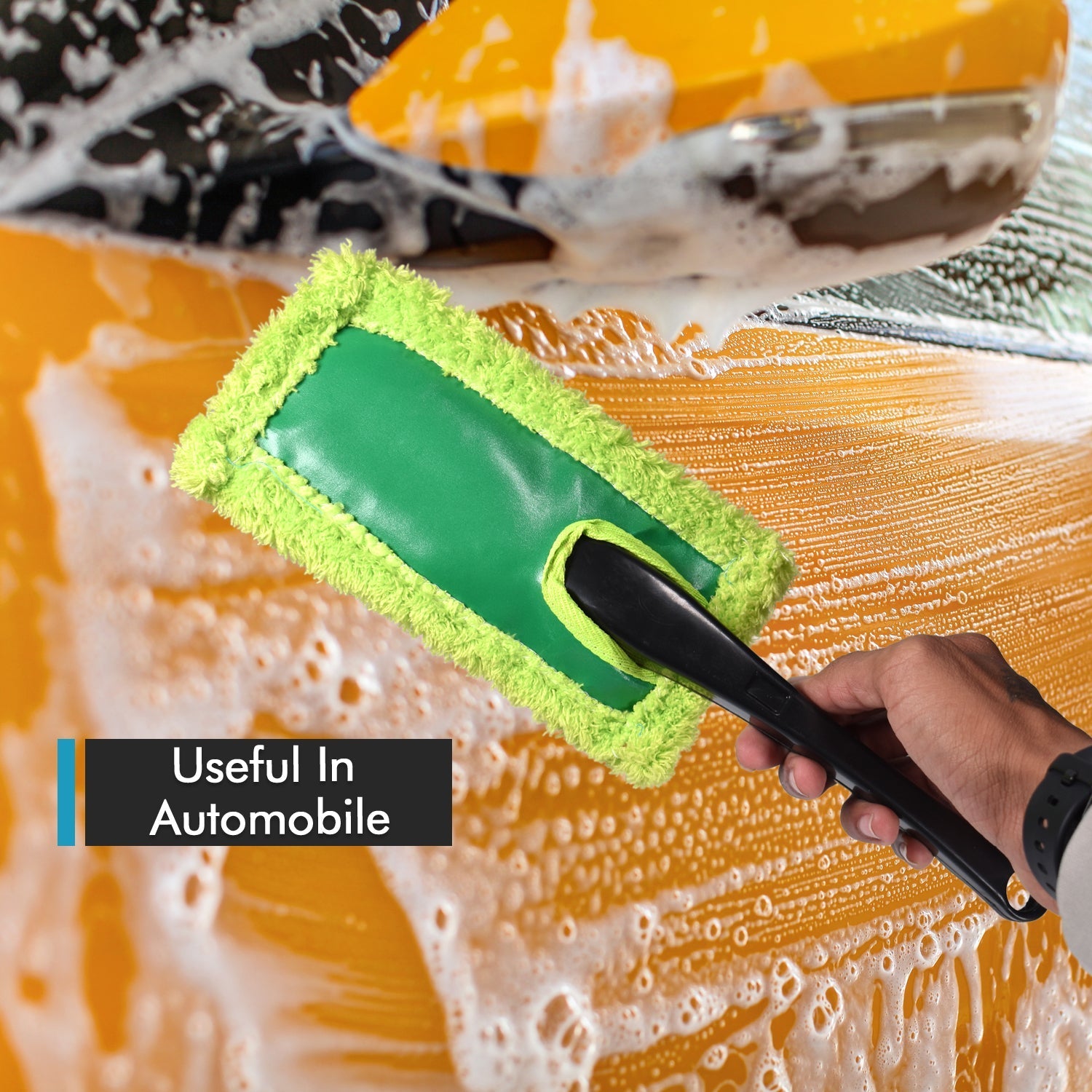 Large, soft microfiber duster trapping dust from a car's exterior for a clean finish.