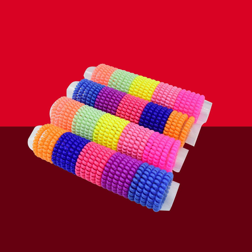 A collection of colorful telephone wire hair bands scattered on a surface.