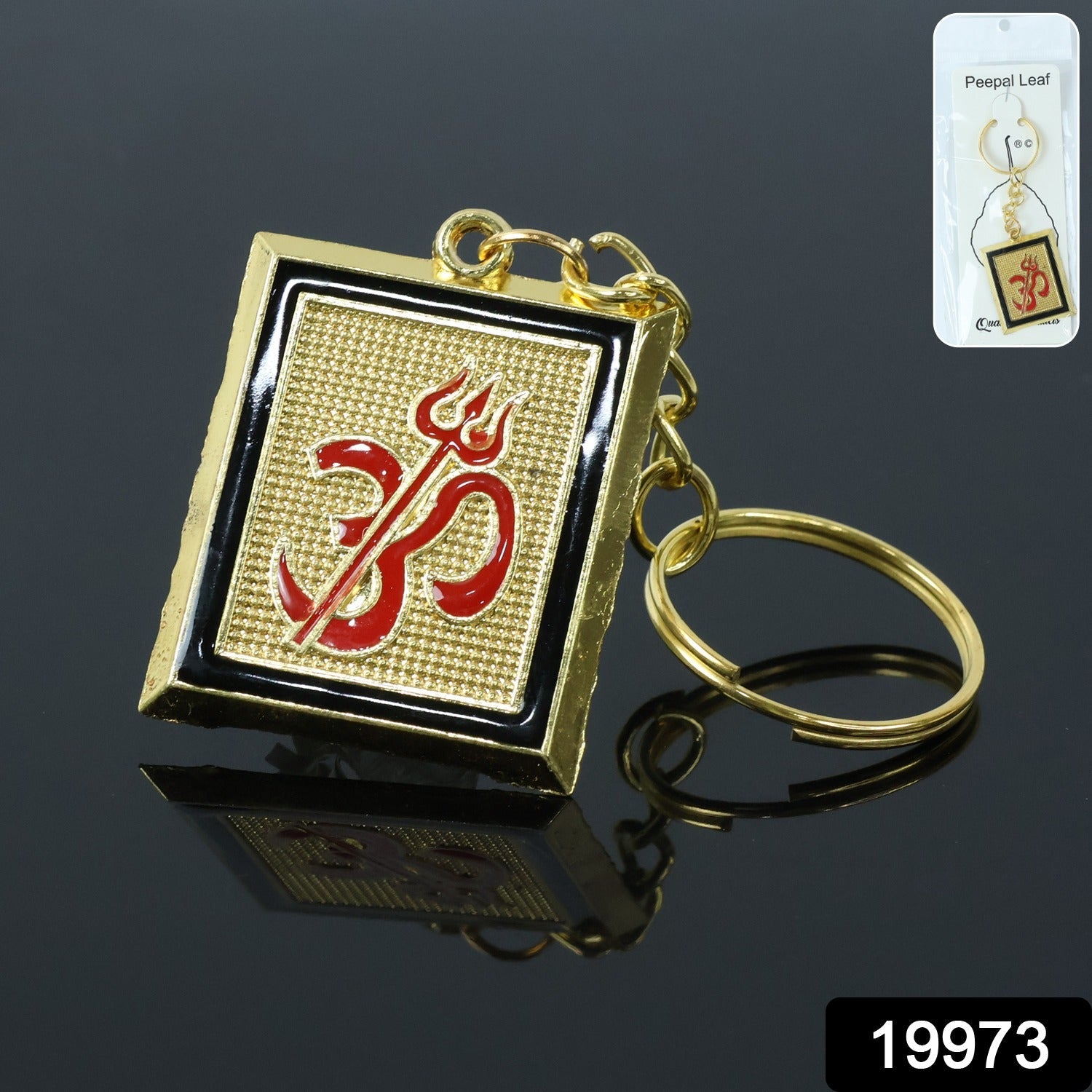 Close-up of metal keychain featuring Om Trishul symbol in golden finish