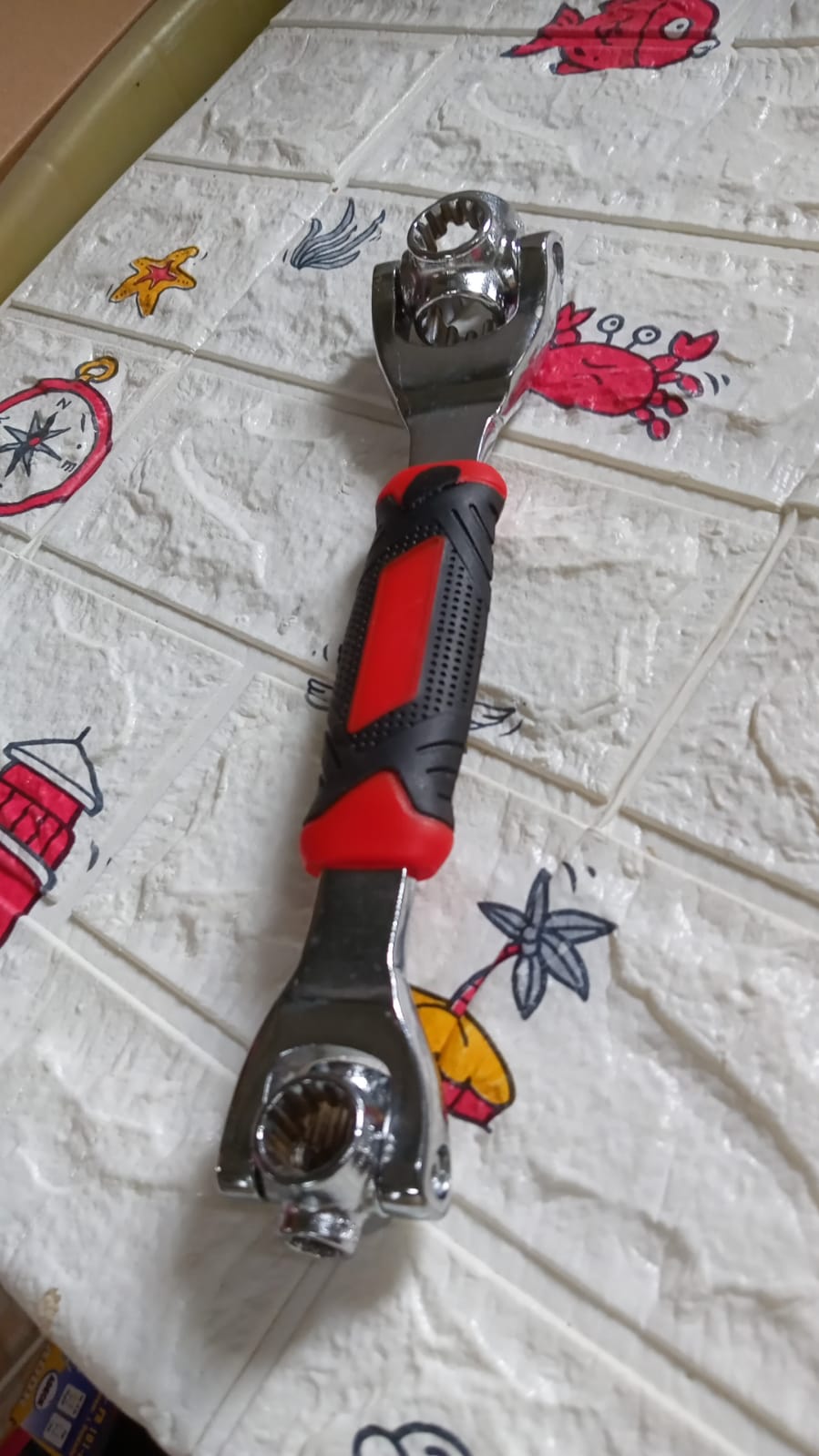 Full view of the multi-function tool, emphasizing its swivel head and multiple sockets.