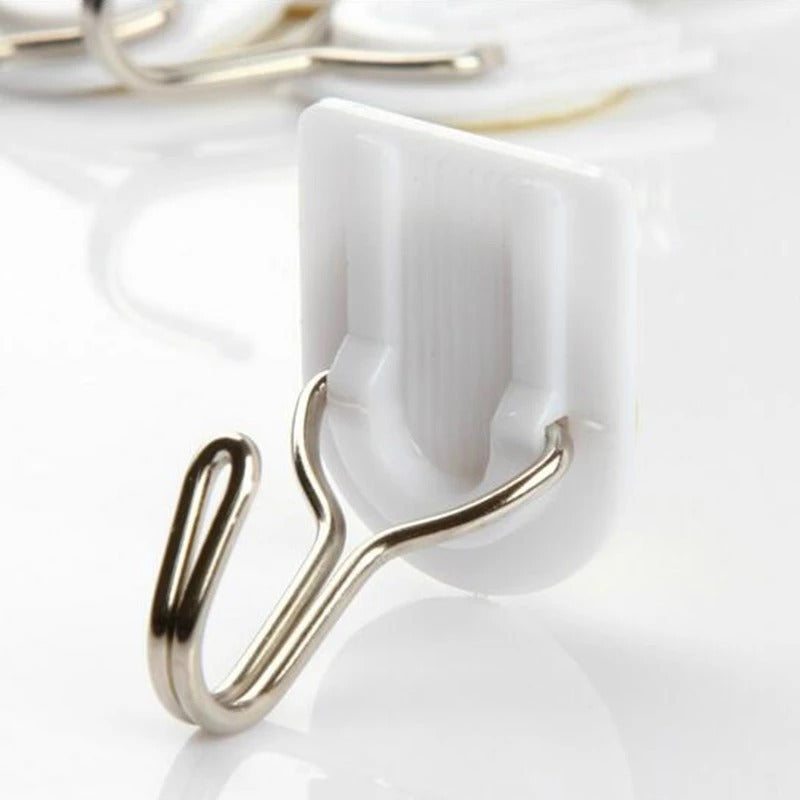 White self-adhesive wall hook for hanging kitchen towels.