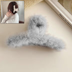 Elegant plush hair claw clip in a vibrant color, perfect for securing hair.