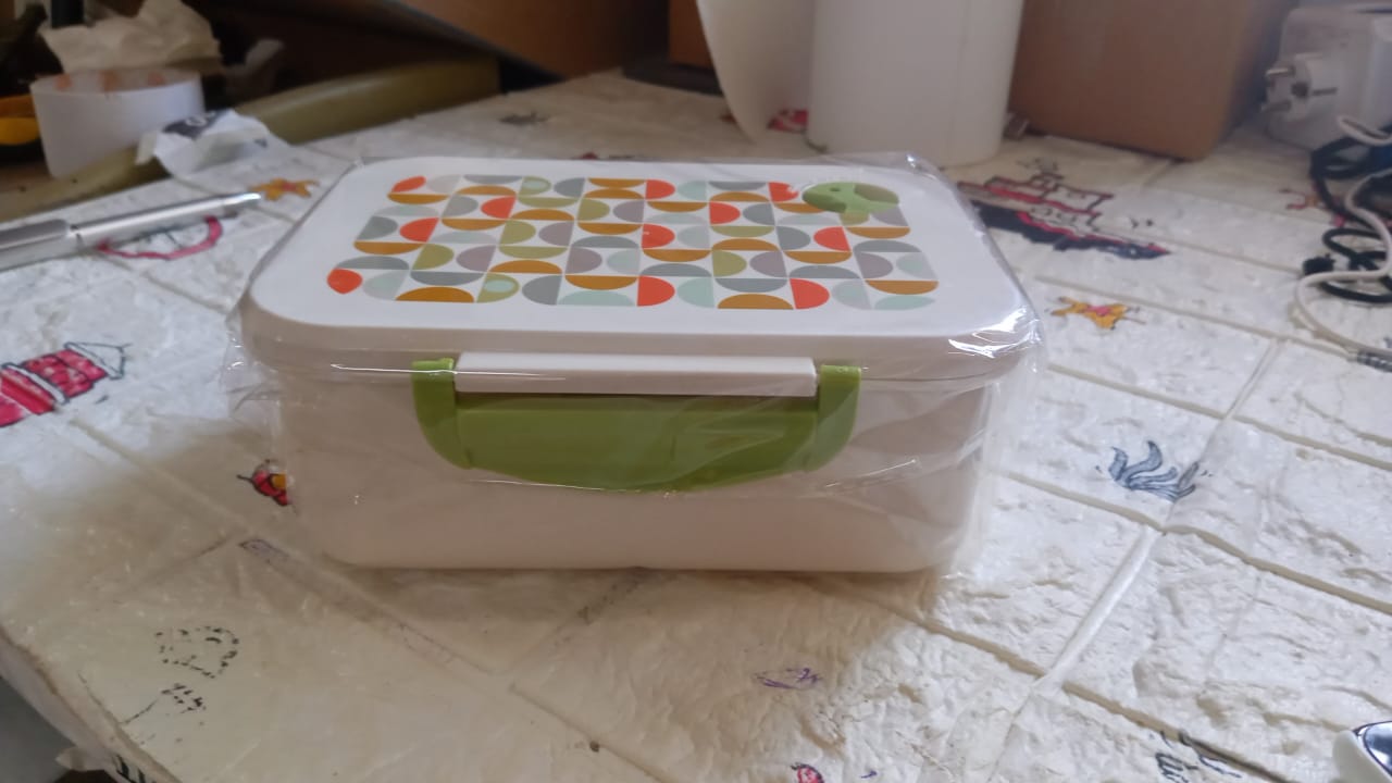 Complete view of the 3 compartment lunch box with its integrated spoon and secure clasps.