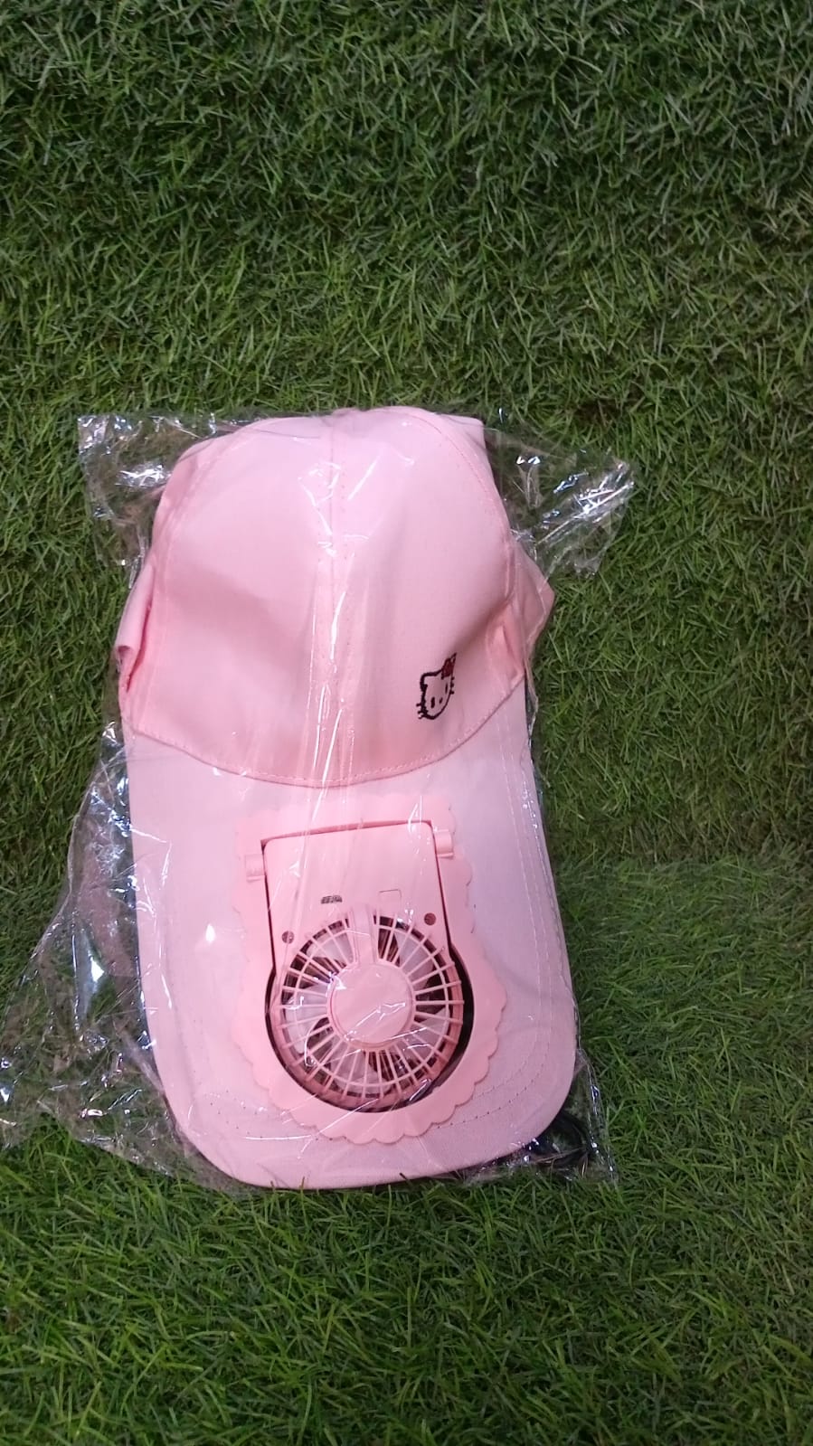 An individual enjoying the sun while wearing the Rechargeable Fan Cap for ultimate comfort.