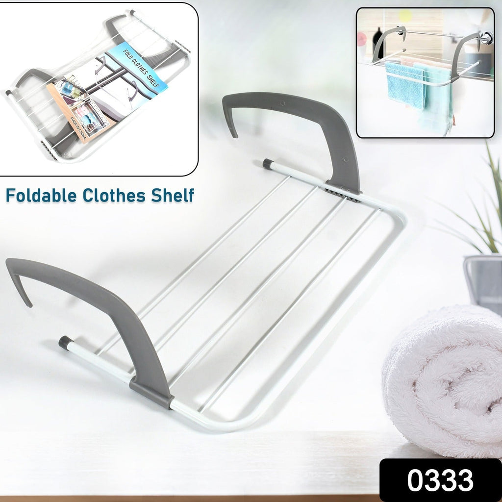 Compact folding drying rack securely attached to a balcony railing, ideal for outdoor use.