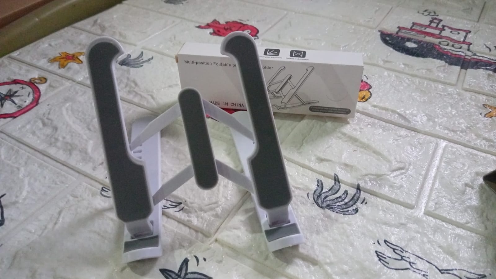 The adjustable tablet stand folded flat, ready for portability.