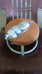 Another view of the white low height rolling stool, emphasizing its compact size.