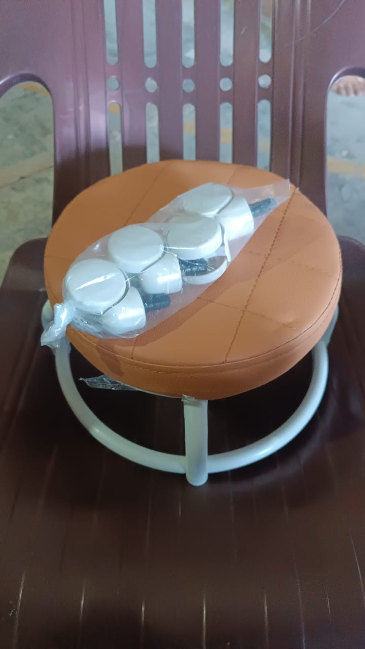 Another view of the white low height rolling stool, emphasizing its compact size.