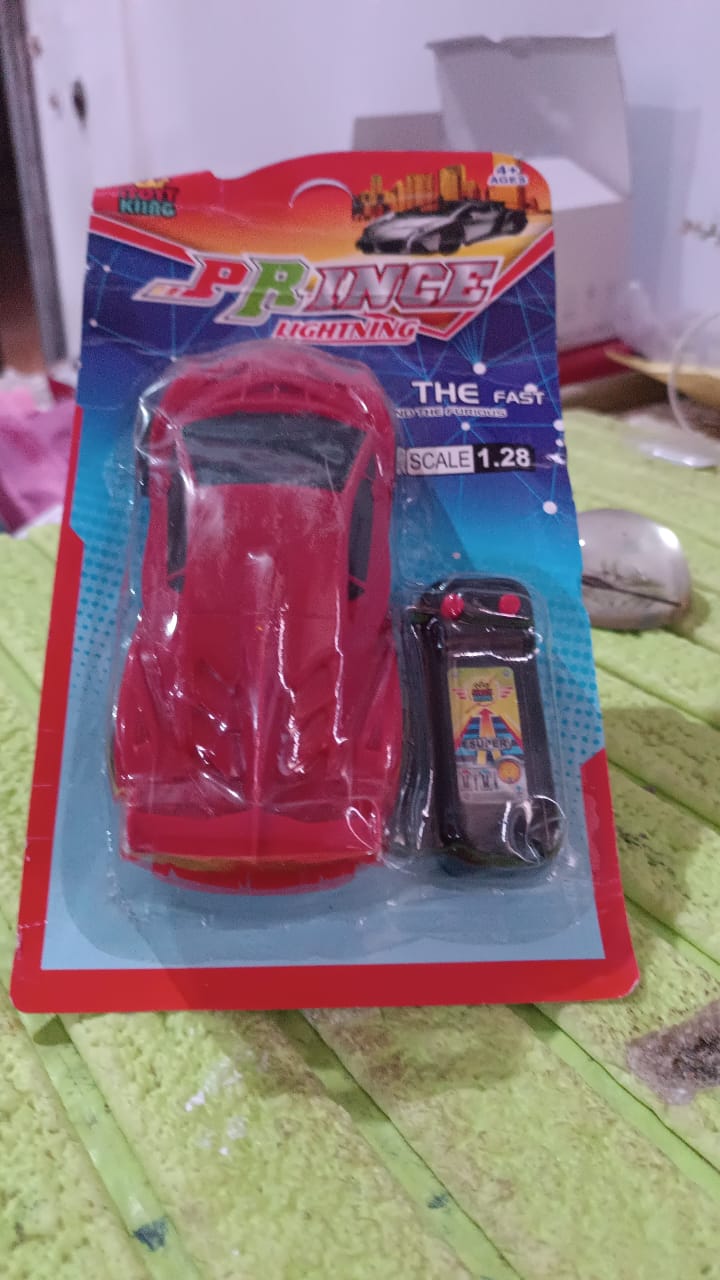 The remote control racing toy car speeding across an indoor surface, ideal for kids' fun.