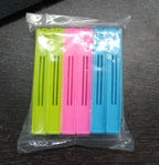 Overhead view of the 18-piece plastic snack bag clip set.
