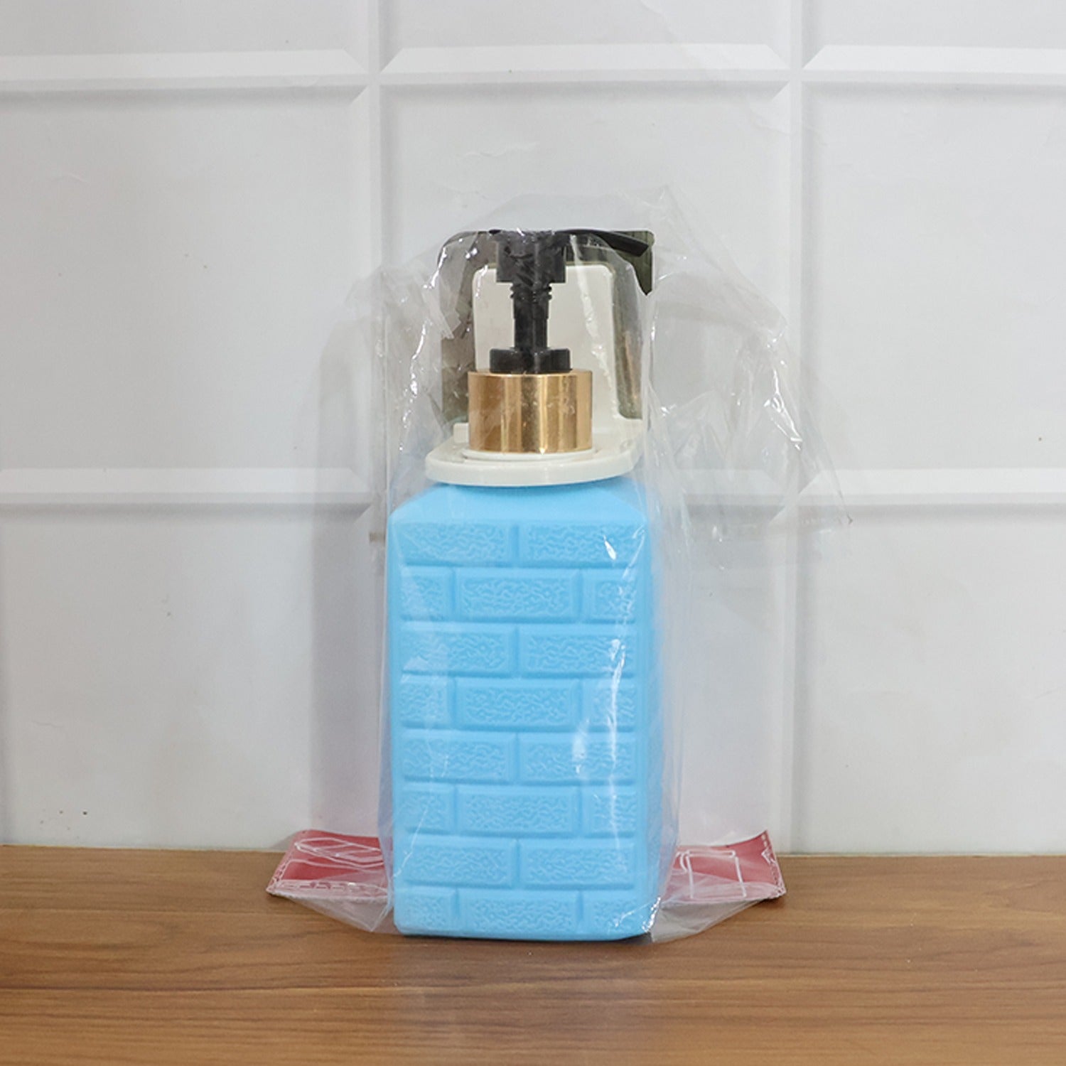Alternate angle of wall-mounted liquid soap dispenser mounted on wall
