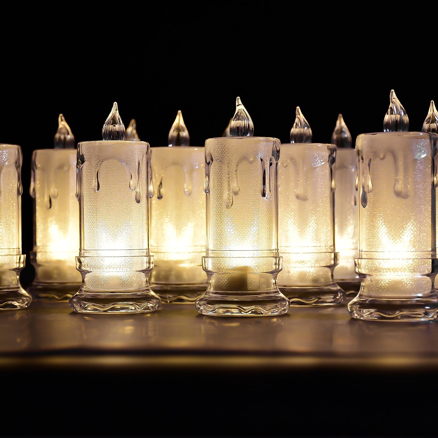 A charming group of Melted Design Flameless Candles casting a warm, inviting glow in a room setting.