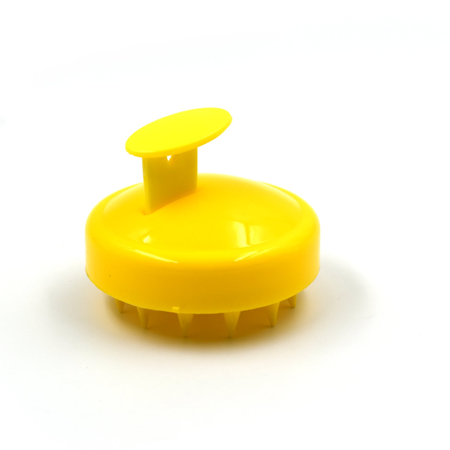 Scalp massager brush showing its compact and travel-friendly design.