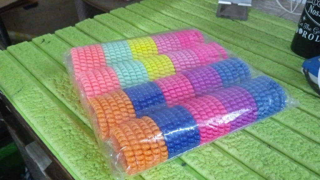 Various telephone wire hair bands in different colors arranged together.
