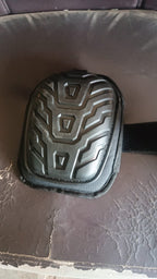 Heavy-duty knee pad displayed upright showcasing its protective shell and padding
