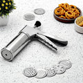 Stainless steel kitchen press with 15 interchangeable discs for making various Indian snacks.