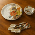 18-piece plastic dinner set with floral design, showing plates, bowls, and spoons.