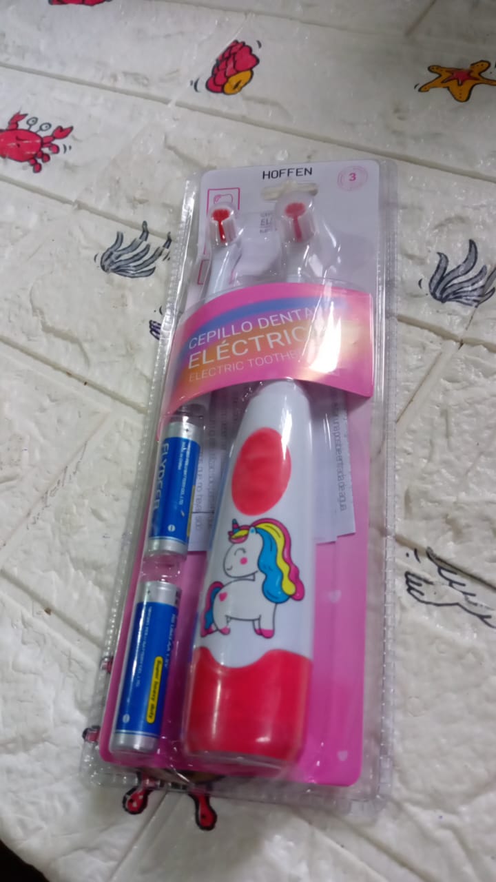 Complete electric toothbrush set, ready for travel or home use.