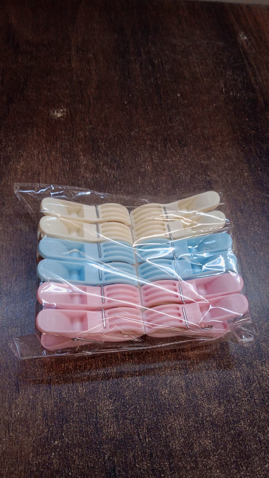 Colorful plastic cloth clips arranged neatly in rows for easy selection