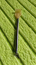 The compact back scratcher displayed neatly in its product packaging.