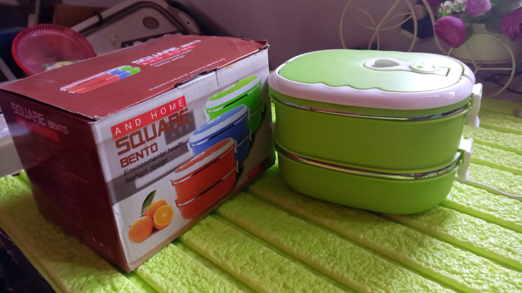 A person holding the portable leakproof bento lunch box, ready for travel.