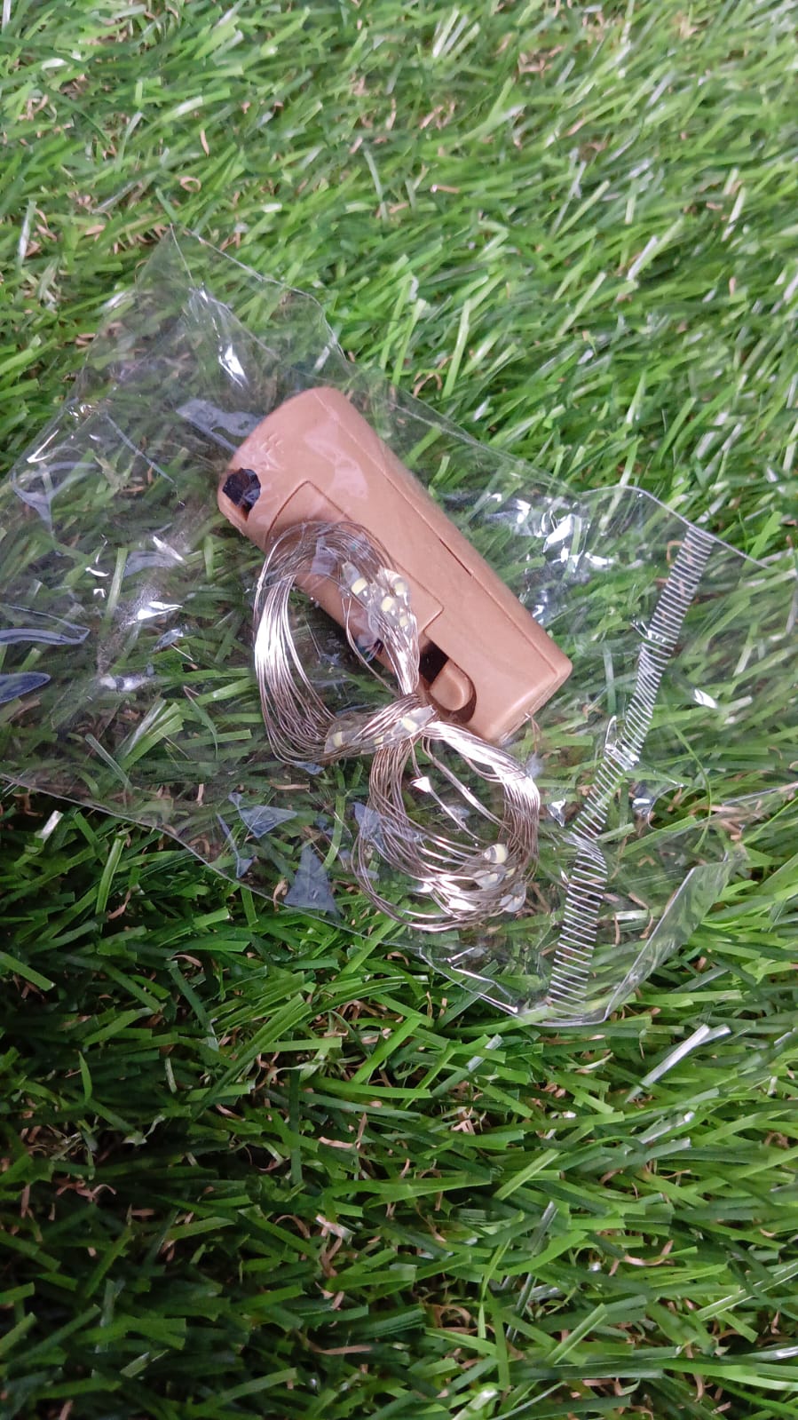 A detailed view of the compact battery compartment within the wine bottle cork.