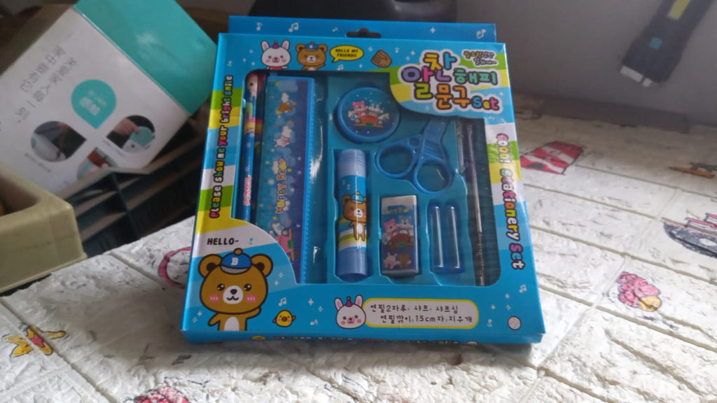 Compact stationery kit with safety scissors and a functional pencil sharpener.