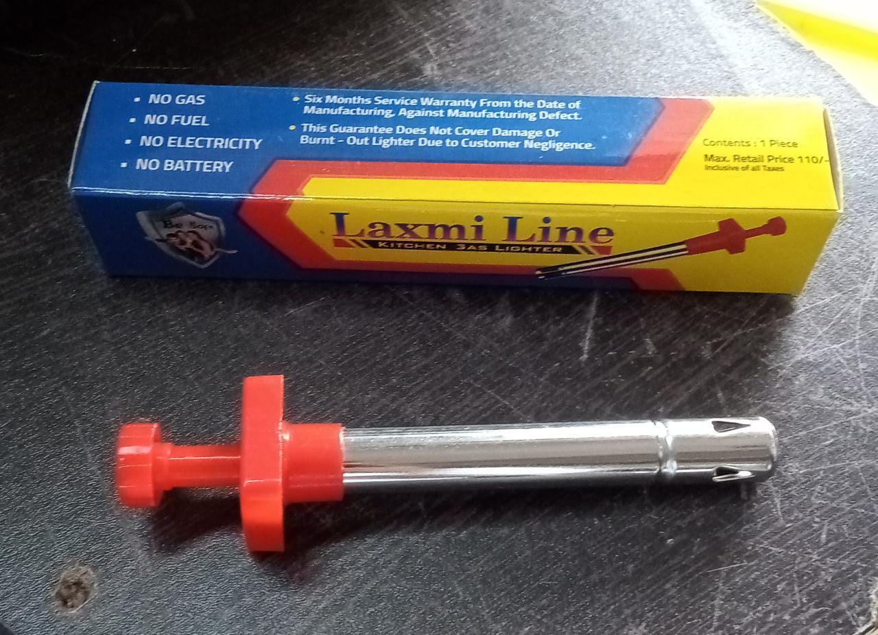 Person holding the stainless steel gas lighter, demonstrating its practical use.