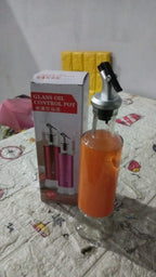 The glass oil dispenser with its lid closed, highlighting the secure and dust-proof design.