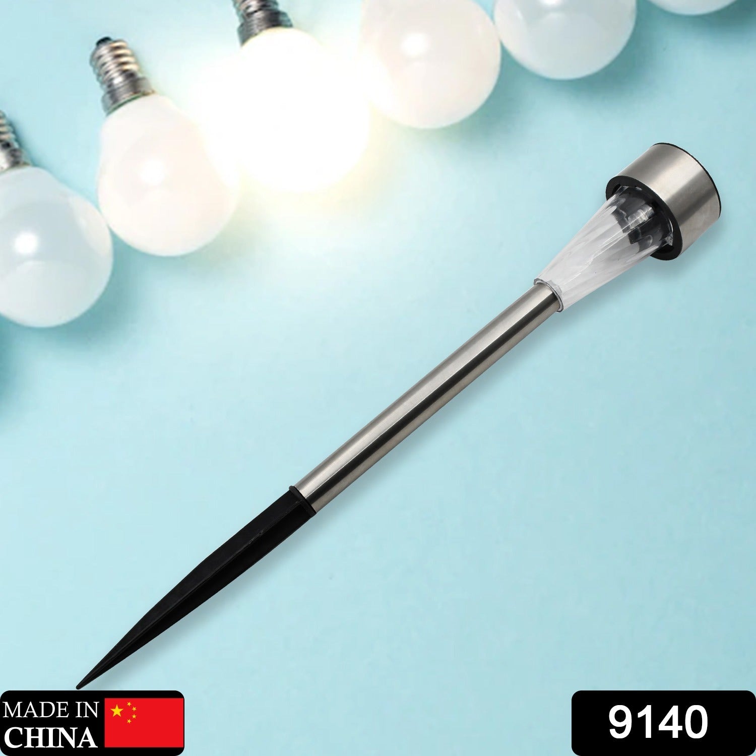 Outdoor solar lamp with a ground spike, casting a warm glow on a garden landscape.